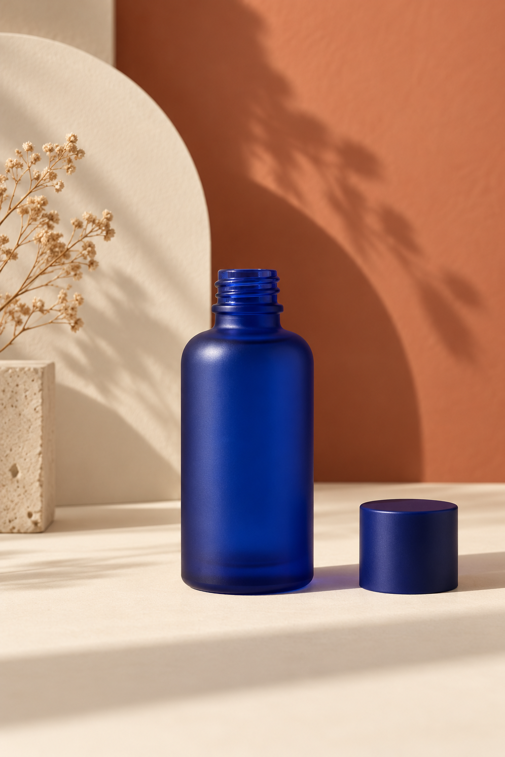Blue glass product bottle in an honest catalog composition